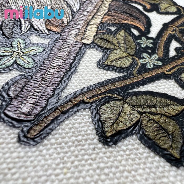 Close-up of miilabu puff print fabric with textured botanical embroidery, made from GRS, BCI, and OCS certified canvas, recycled cotton, RPET, organic cotton, T/C fabric, satin, Martindale, oxford, and waterproof outdoor bag materials.