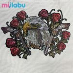 Embroidered puff print fabric featuring an eagle, roses, and revolvers, suitable for eco bags, handbags, and outdoor products.